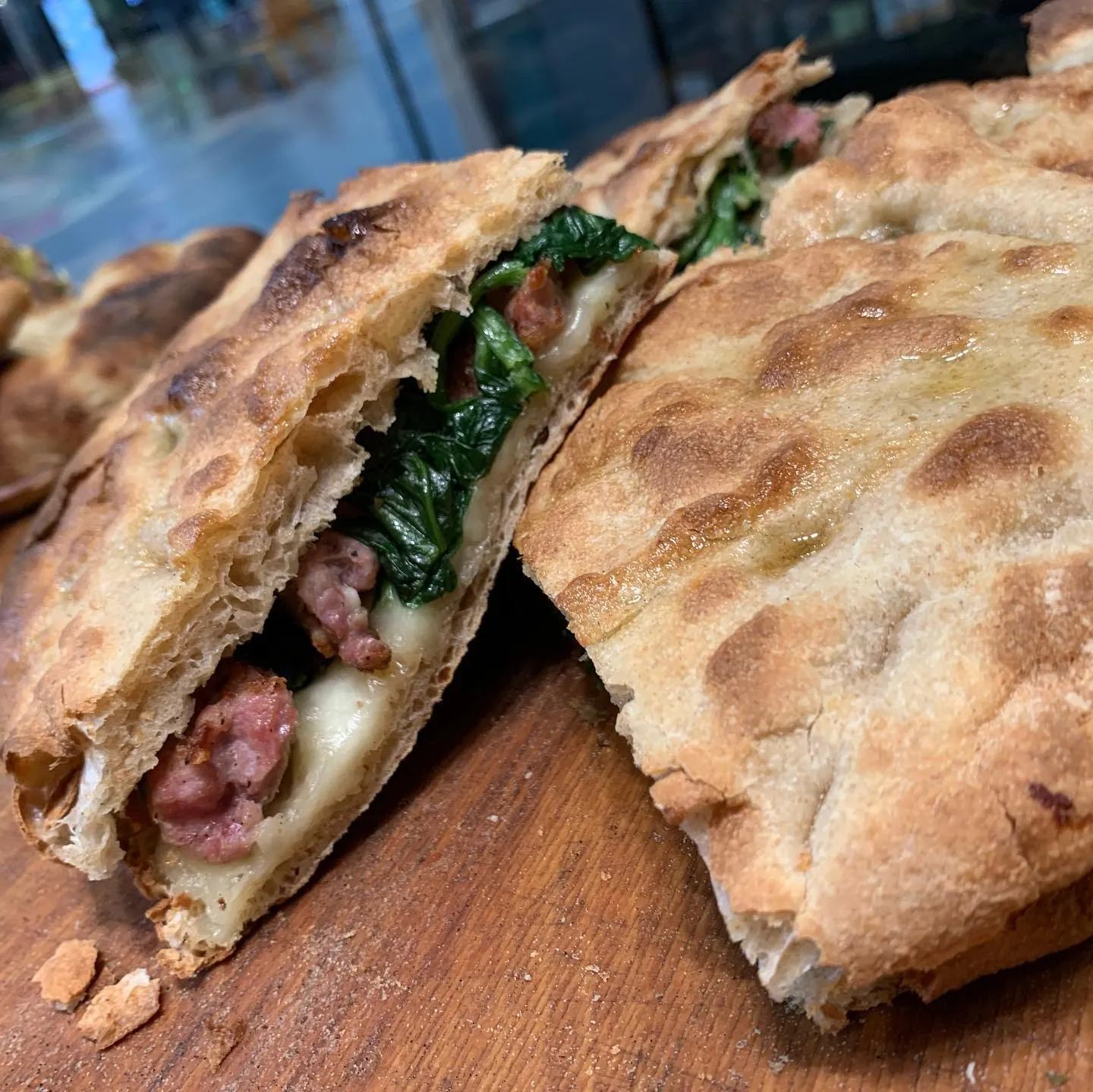 Calzone ripieno di salsiccia e spinaci tagliato a metà